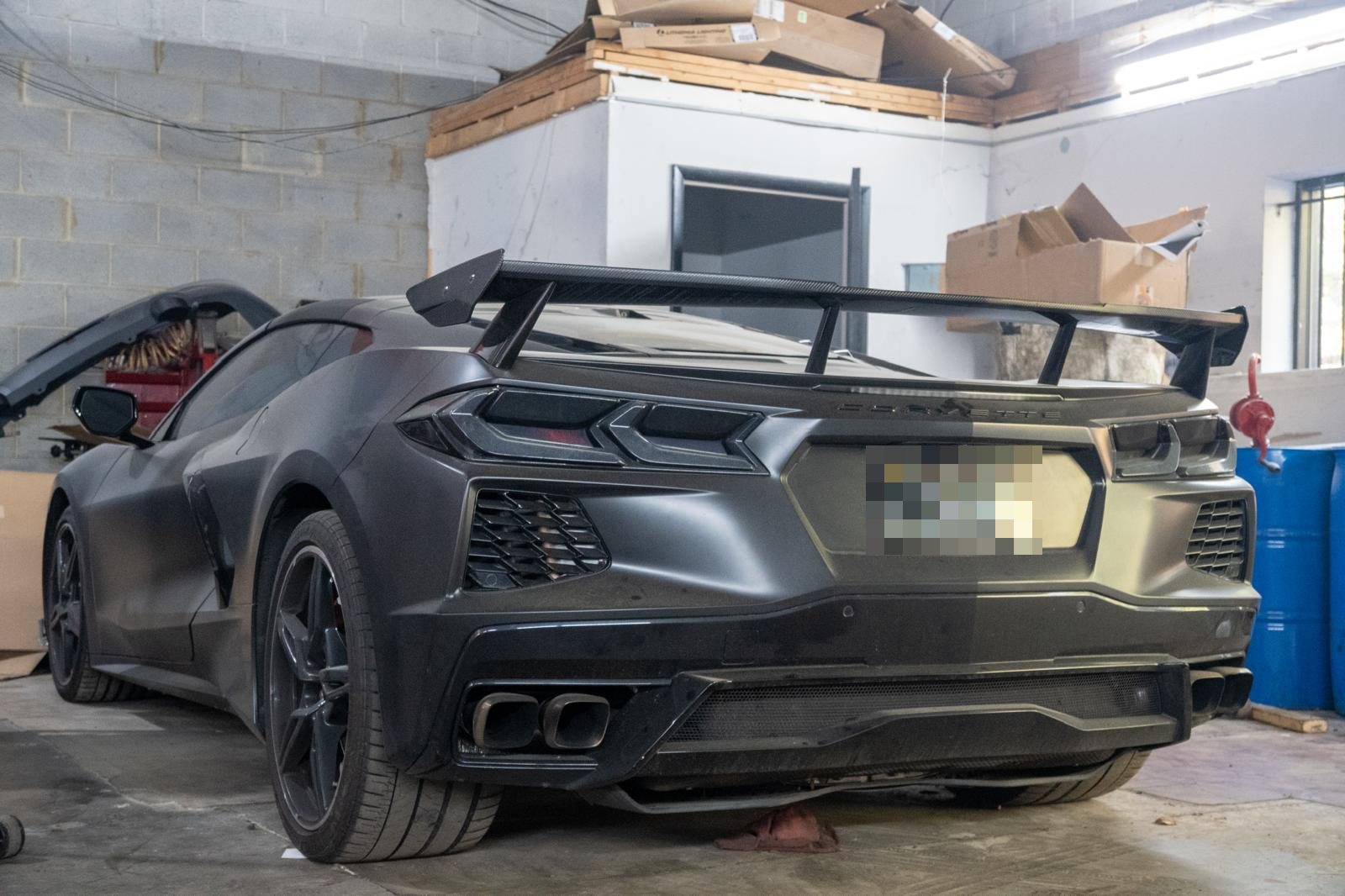 Matte gray C8 Corvette with a carbon wing in the bay