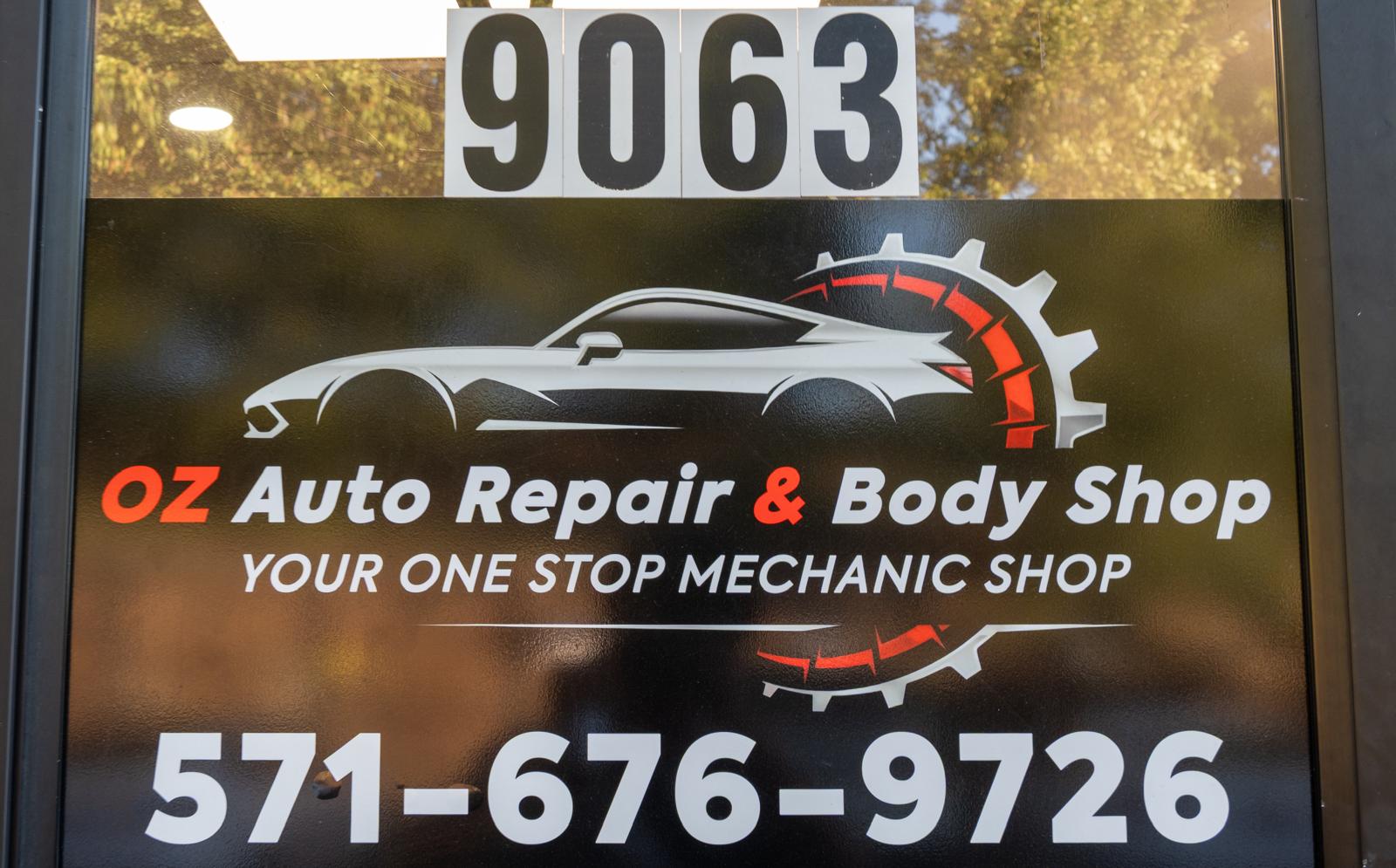 OZ Auto Repair & Body Shop sign on the door at 9063, with phone number 571-676-9726