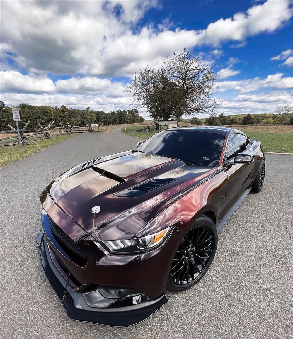 Deep cherry Ford Mustang GT with a vented hood