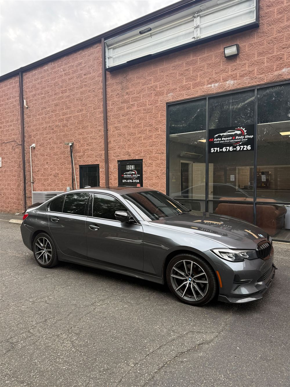 Gray BMW 3 Series outside the shop
