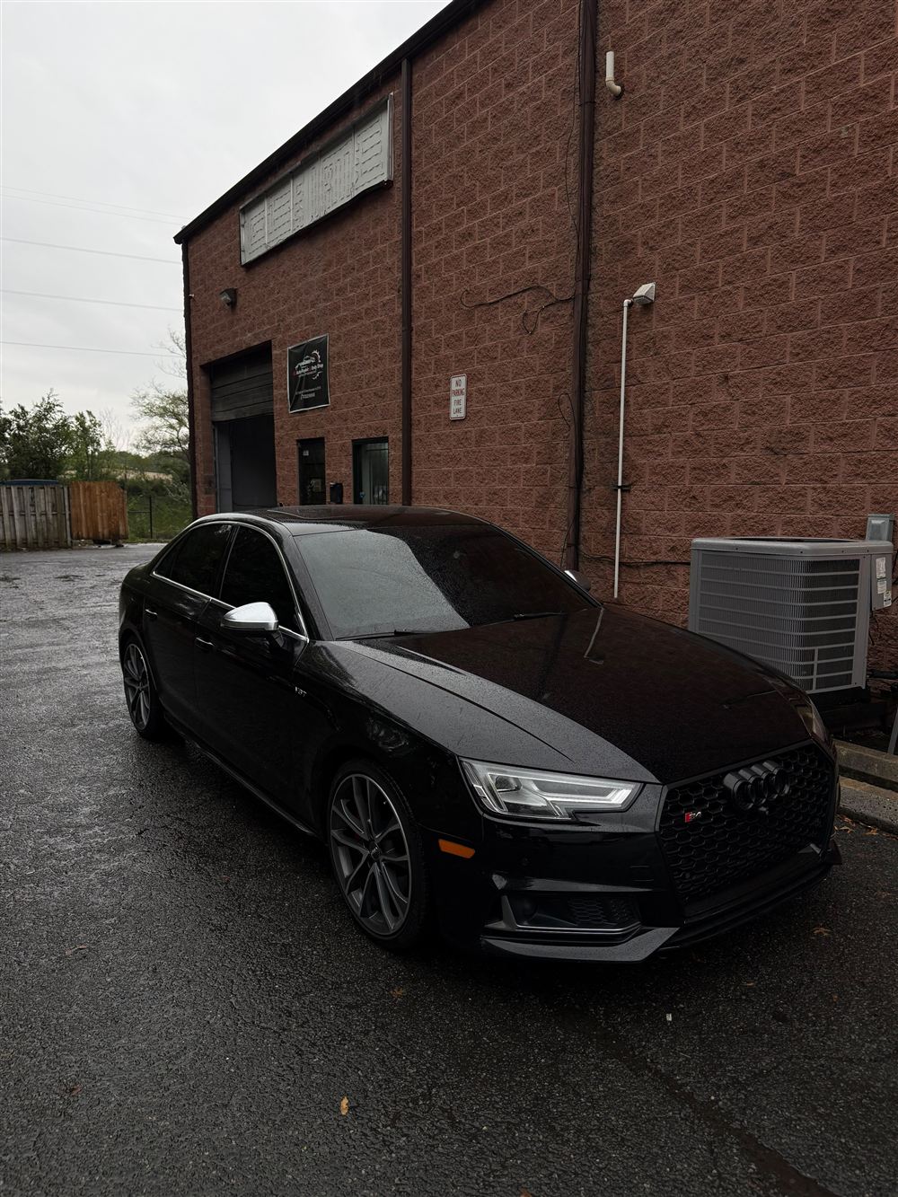 Black Audi sedan outside the shop