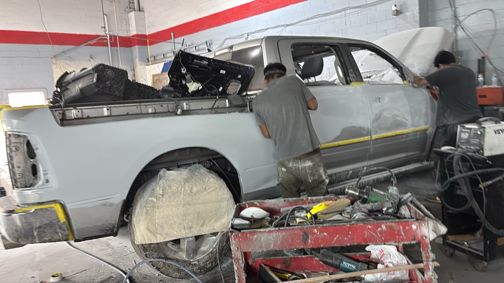 Truck in primer and silver paint in the bay